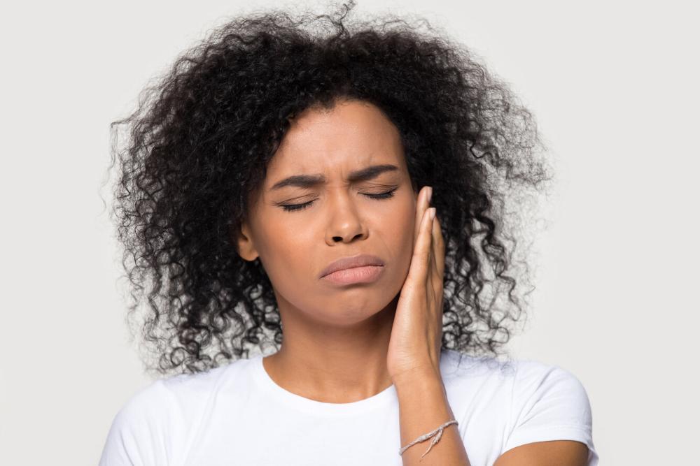 woman holding jaw from emergency
