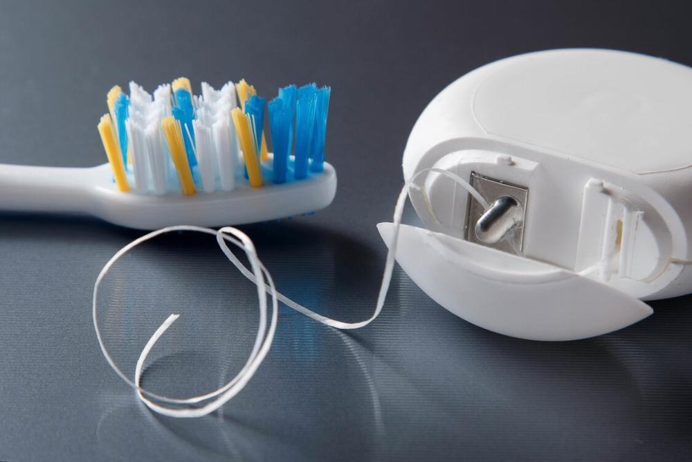dental floss and tooth brush