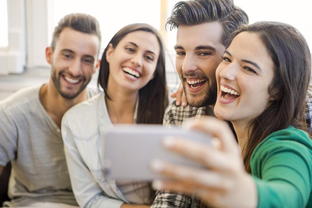 group of friends taking a picture on cell phone