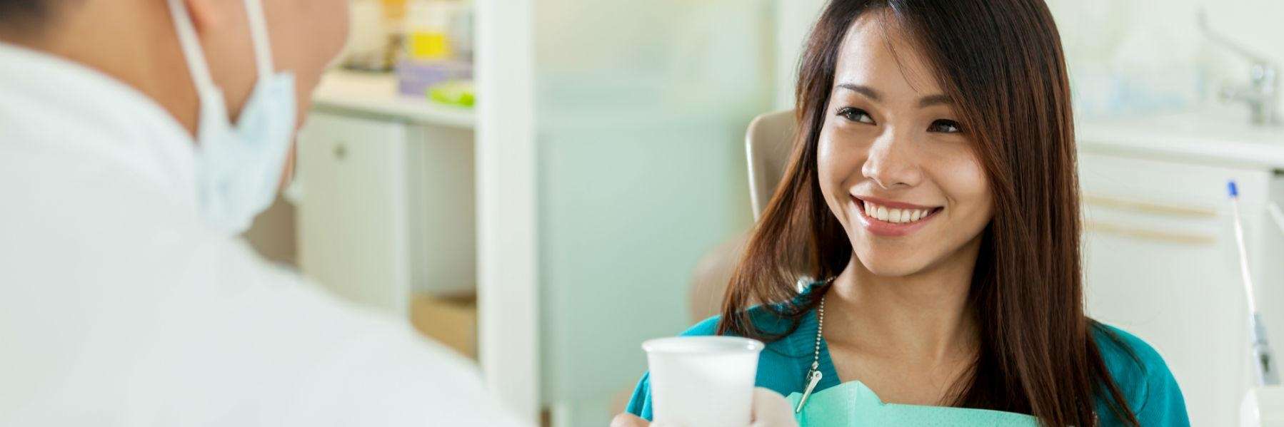 A woman smiling after getting a Gentle Tooth Extraction Services in Northborough, MA