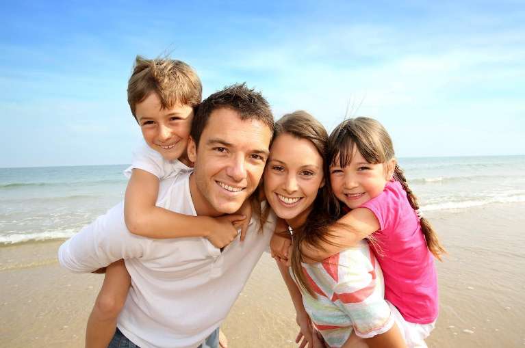 A father smiling with his children after a Dental Care in Northborough, MA