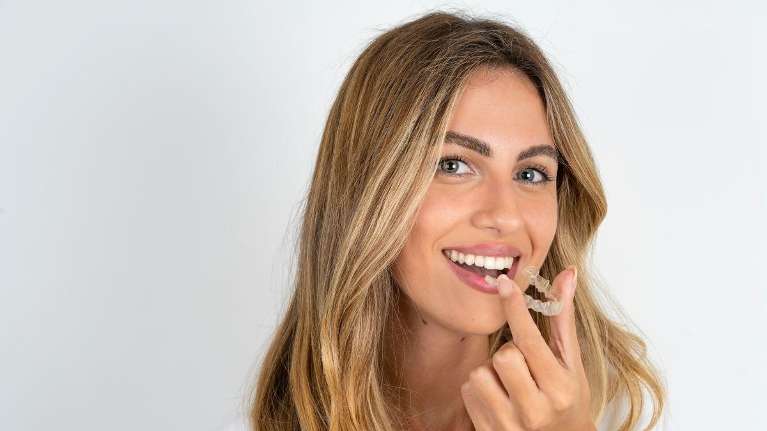 A beautiful woman trying out an Invisalign in Northborough, MA