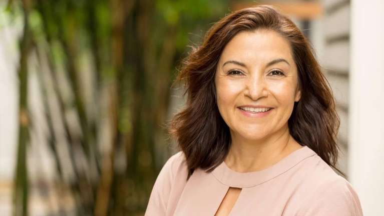 Woman confidently smiling with her dental implant in Northborough