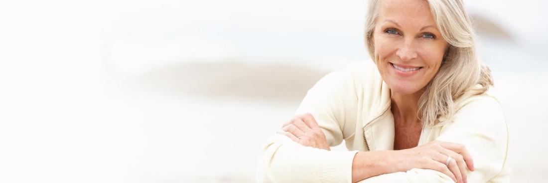 older woman smiling on beach