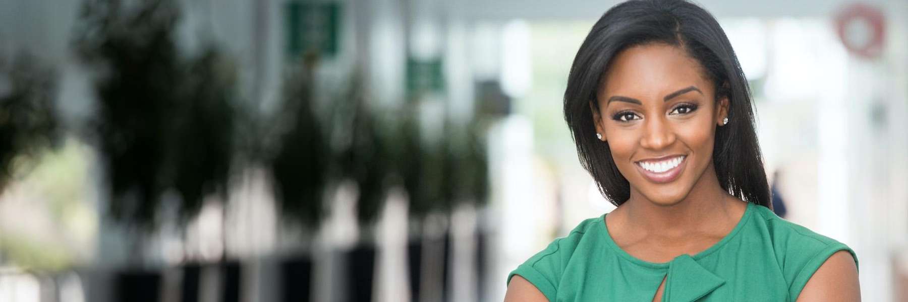 Black woman in a green shirt with a healthy full set of teeth in Northborough